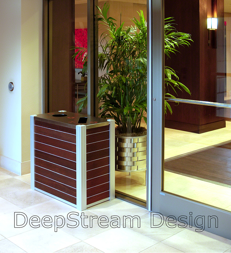 Top loading Audubon Modern Wood Combination Recycling and Trash Receptacle in a hotel lobby